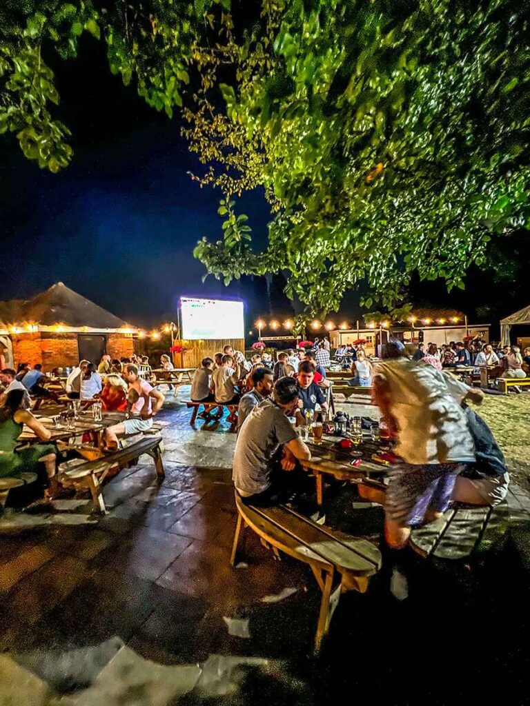 The rear beer garden of the British Oak Pub Birmingham with people sat drinking beer