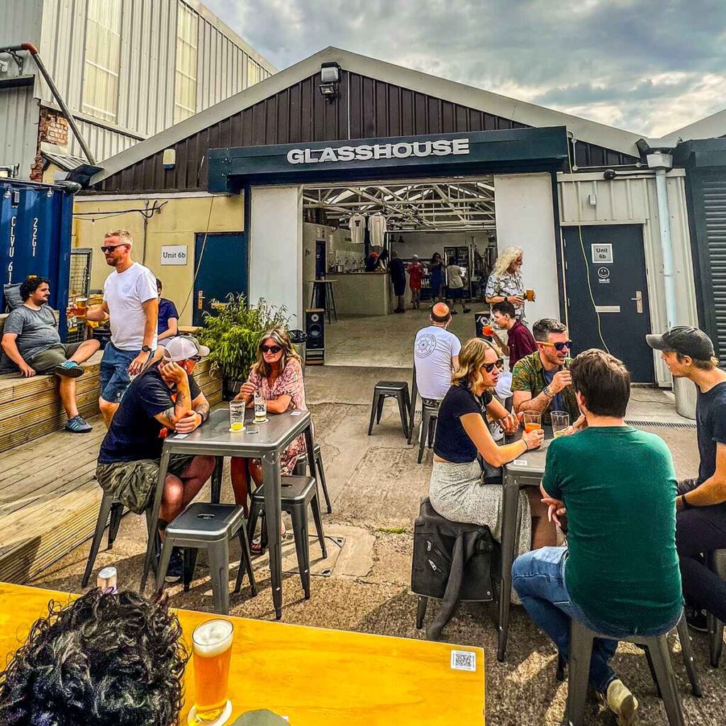 People sat in the beer garden drinking beer in the glasshouse, Birmingham