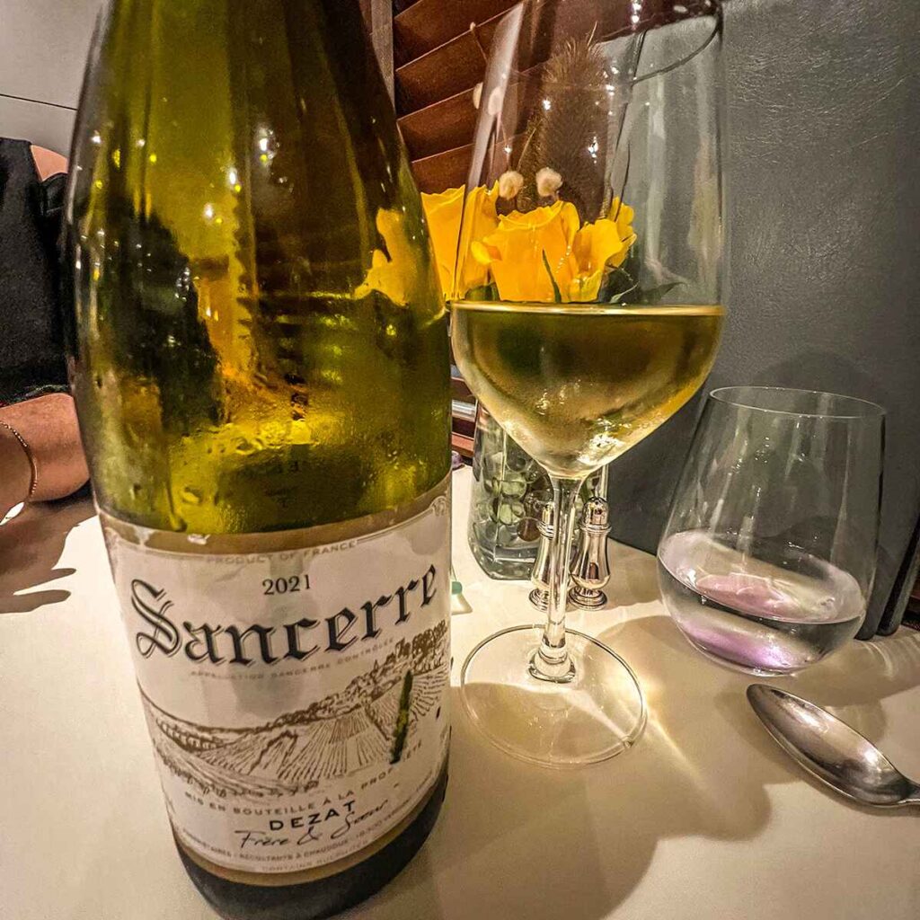 Glass and bottle of French wine on a table