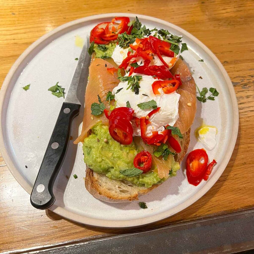 Avocado toast, smoked salmon and poached egg, with chilli sprinkled brunch at The Plough, Harborne