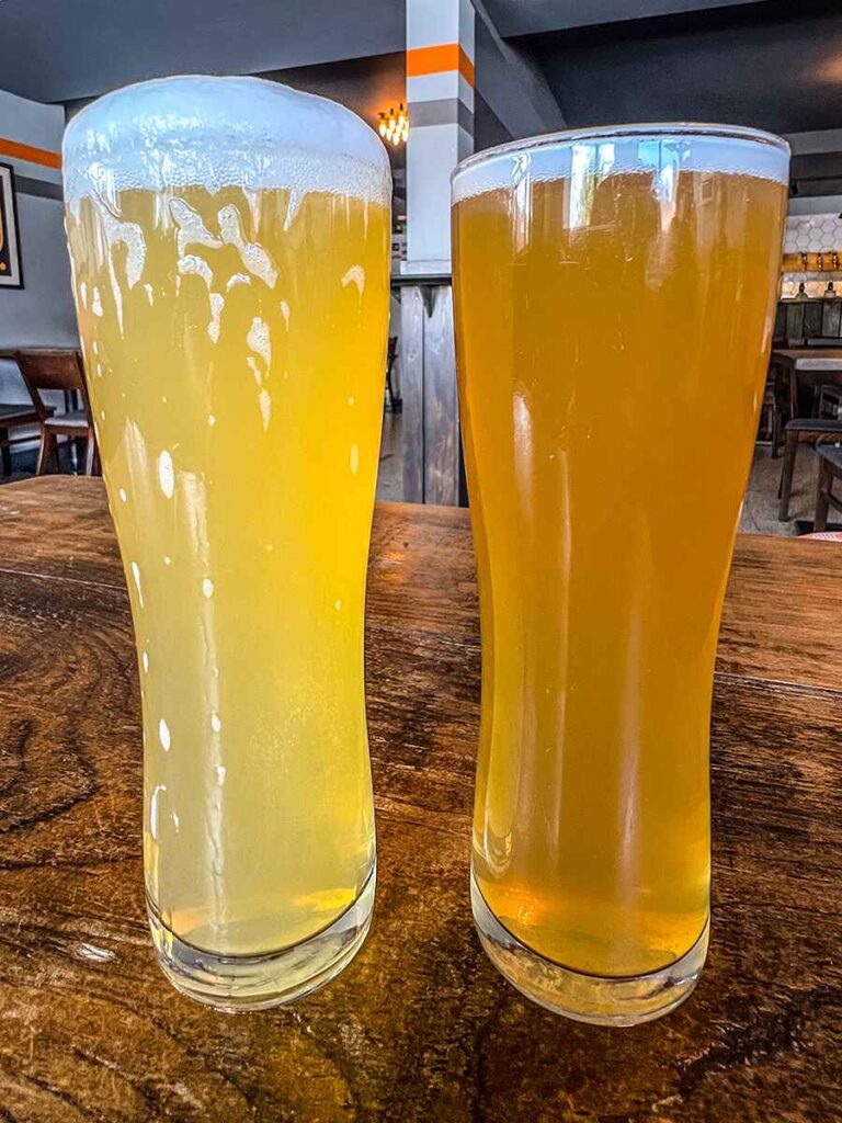 Close up of two pints of craft beer, one slightly lighter coloured