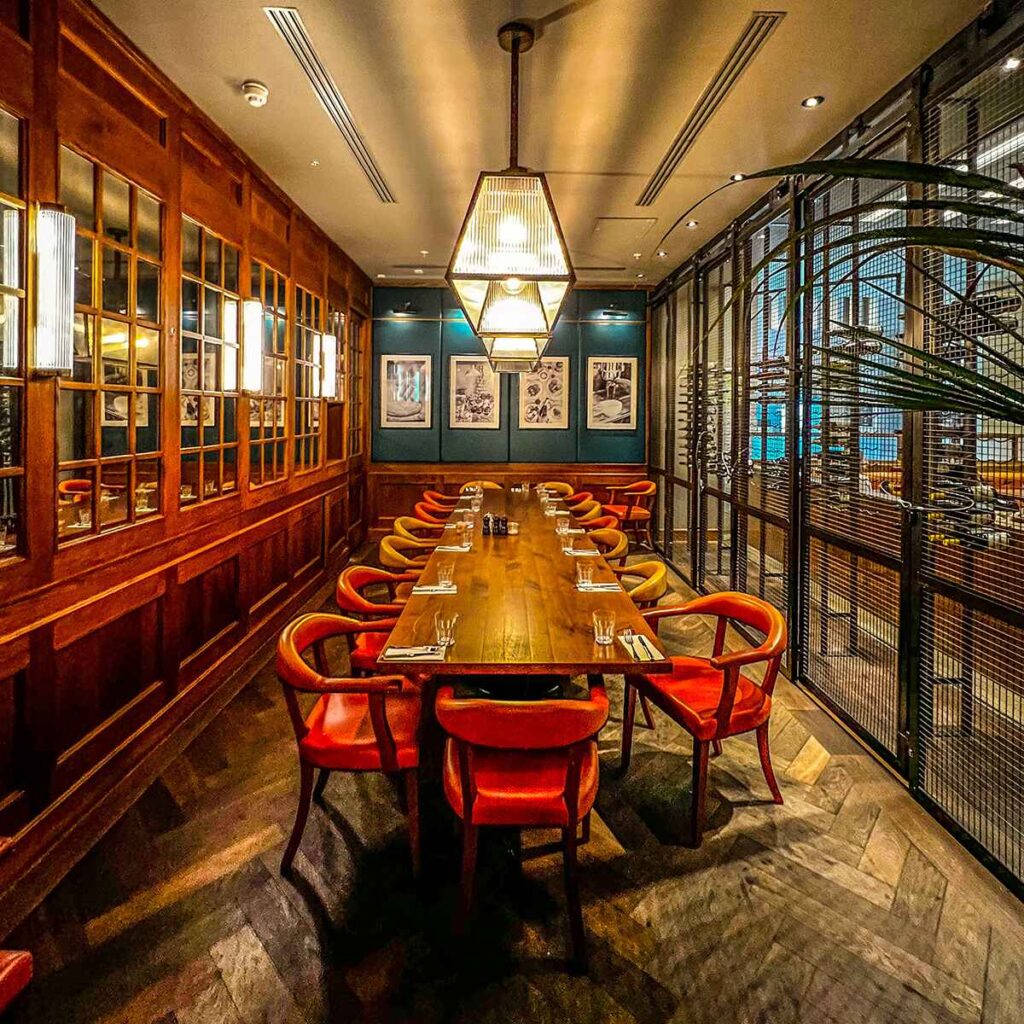 Long dramatic table and chairs inside Medicine bakery Birmingham