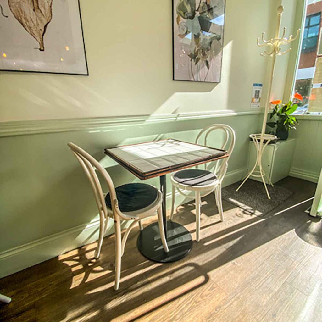 Two chairs and table bathed in sunlight at Pauls 41 Harborne