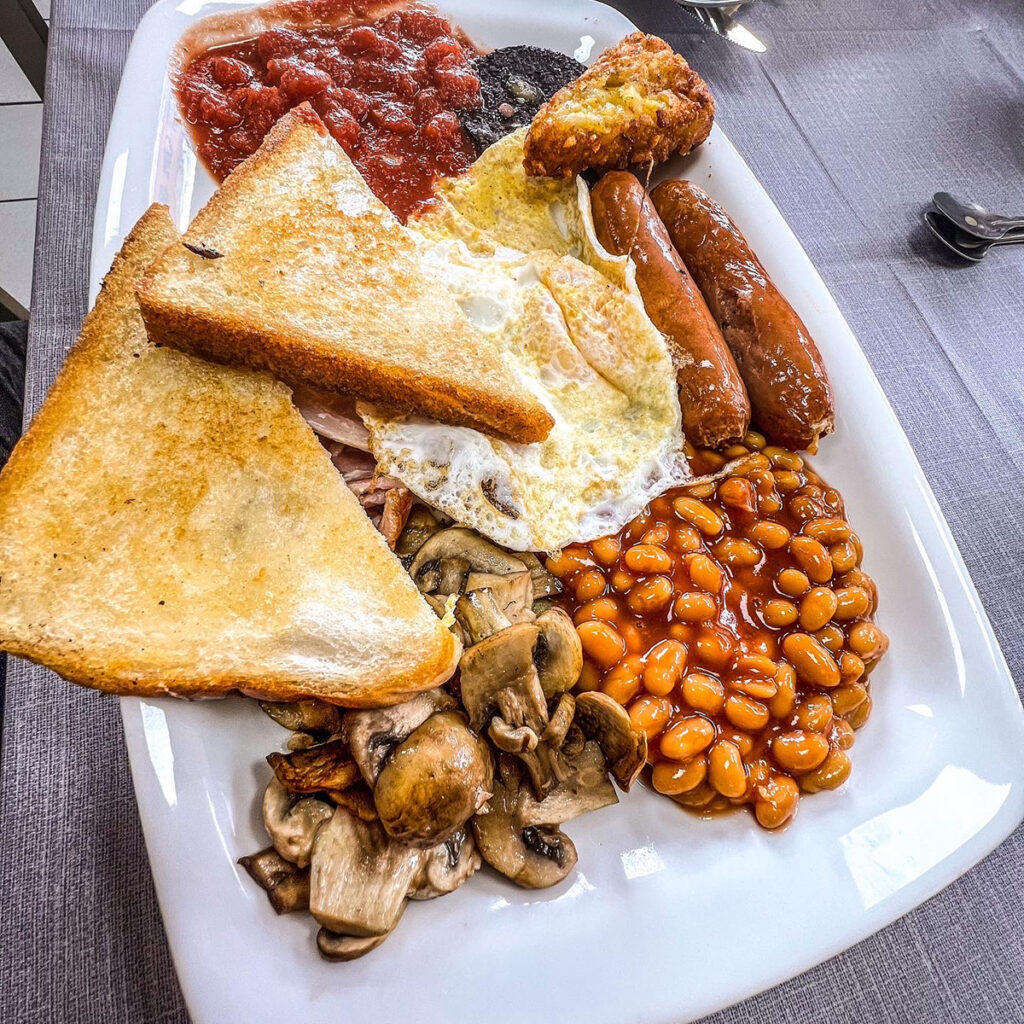 A hearty full English breakfast served on a plate at Bournville cafe.

